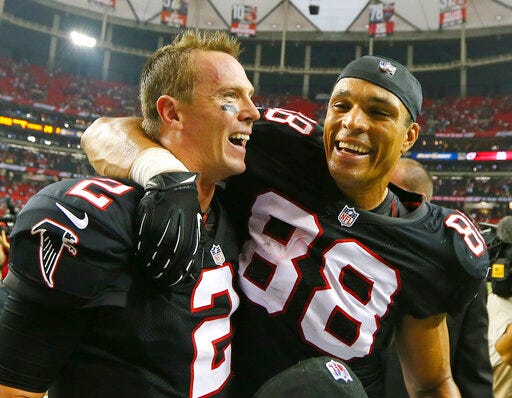 FILE - In this Sept. 30, 2012, file photo, Atlanta Falcons quarterback Matt Ryan, left, and tight end Tony Gonzalez celebrate a 30-28 victory over the Carolina Panthers in an NFL football game at the Georgia Dome in Atlanta. Matt Ryan believes Tony Gonzalez already was a lock for the Hall of Fame before being traded from Kansas City to Atlanta in 2009. Still, it took the Falcons’ quarterback some time to finally believe Gonzalez when the tight end kept saying he was open despite being covered by two or three defenders. (AP Photo/Atlanta Journal & Constitution, Curtis Compton, File)