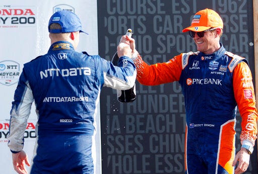 Scott Dixon, right, celebrates with teammate and second-place finisher Felix Rosenqvist after winning an IndyCar Series auto race, Sunday, July 28, 2019, at Mid-Ohio Sports Car Course in Lexington, Ohio. (AP Photo/Tom E. Puskar)