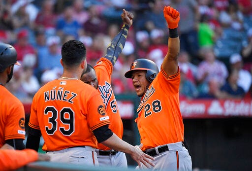 Baltimore Orioles' Pedro Severino, right, celebrates with Renato Nunez, left, and Hanser Alberto after hitting a two-run home run during the third inning of a baseball game against the Los Angeles Angels, Saturday, July 27, 2019, in Anaheim, Calif. (AP Photo/Mark J. Terrill)