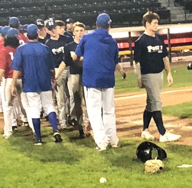 Exeter Post 32 players shake hands with Nashua after their game in the American Legion state tournament in Nashua on Sunday night. Post 32 lost, 5-1. [Chris Pantazis/Nashua Telegraph]