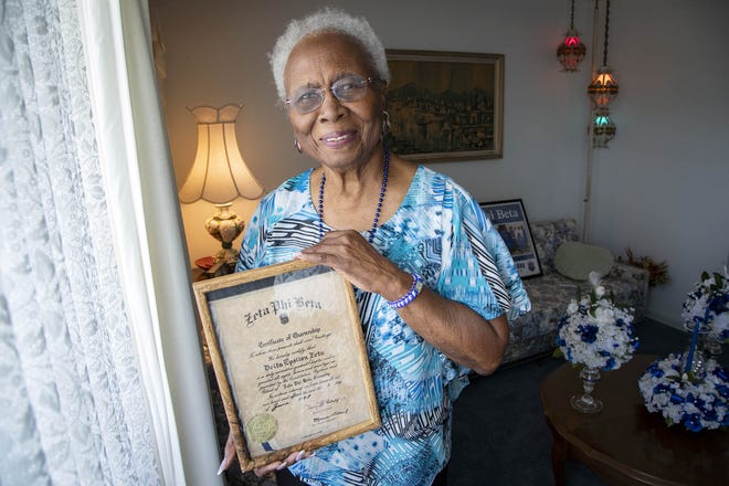 Elizabeth Stubbs-Munnings, 93, a founding member of Delta Epsilon Zeta, holds its charter dated June 1, 1949. The sorority and has been involved in hundreds of community projects since its inception over 70 years ago. [ALLEN EYESTONE/palmbeachpost.com]