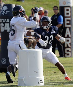 Chicago Bears running back David Montgomery, right, works with linebacker Joel Iyiegbuniwe during training camp Sunday, July 28, 2019, in Bourbonnais. [NAM Y. HUH/THE ASSOCIATED PRESS]