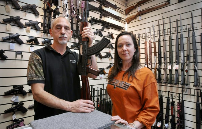 In this 2015 photo, Scott Malkasian and partner Alicia Merritt, co-owners of Pullman Arms in Worcester, pose at the gun shop. [T&G Staff/Paul Kapteyn]