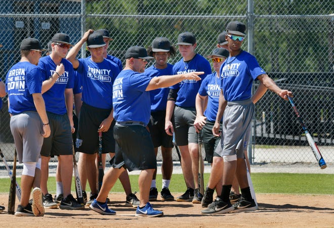 Trinity Christian Academy baseball coach Gil Morales (center) talks to his team during a team practice in May. [Will Dickey/Florida Times-Union]
