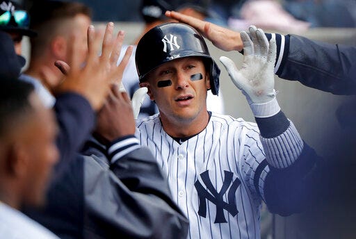 FILE - In this Saturday, March 30, 2019 photo, New York Yankees' Troy Tulowitzki is congratulated by teammates after hitting a solo home run against the Baltimore Orioles during the ninth inning of a baseball game in New York. Shortstop Troy Tulowitzki says he is retiring from Major League Baseball following injuries that limited him to 13 plate appearances since July 2017, Thursday, July 25, 2019. (AP Photo/Julie Jacobson, File)