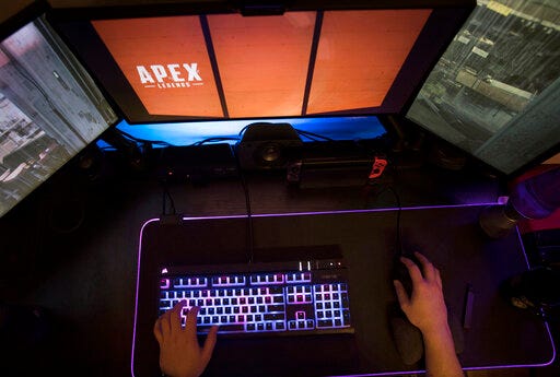 FILE - In this March 6, 2019, file photo a gamer plays Electronic Arts' "Apex Legends" in Jersey City, N.J. Electronic Arts is likely to report lower profit and sales when it reports first quarter earnings on Tuesday, July 30. (AP Photo/Jenny Kane)