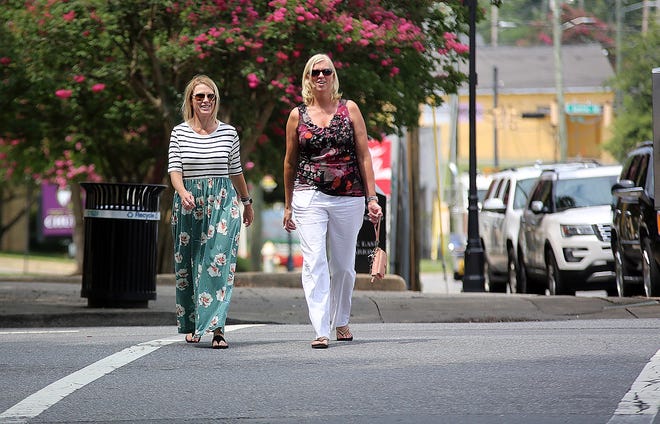From left, Laney Triplett and Tammy Tysinger cross Marion Street in uptown Shelby on Friday. The city is launching a new initiative to promote safety for pedestrians and bikers. [Brittany Randolph/The Star]