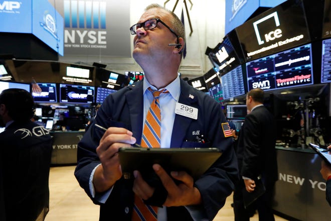 Trader William Lawrence works on the floor of the New York Stock Exchange on July 22. Major U.S. stock indexes closed mostly lower Monday as investors turned cautious ahead of a key Federal Reserve interest policy announcement and other potentially market-moving developments on tap for this week. [AP Photo / Richard Drew]