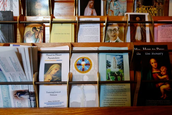 Informational pamphlets for Opus Bono Sacerdotii are displayed with others at The Assumption of the Blessed Virgin Mary Church in Detroit, Friday, June 7, 2019. For nearly two decades, the small nonprofit organization called Opus Bono Sacerdotii, operating out of a series of unmarked buildings in rural Michigan, has provided money, shelter, transport, legal help and other support to priests accused of sexual abuse. (AP Photo/Paul Sancya)