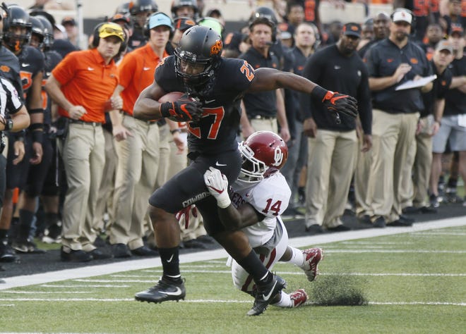 Oklahoma linebacker Emmanuel Beal tackled Oklahoma State J.D. King in the second half of an NCAA college football game in Stillwater, Okla., Saturday, Nov. 4, 2017. King is currently waiting for a verdict on whether or not he can play this year after transferring from Oklahoma State to Georgia Southern this winter. (AP Photo/Sue Ogrocki)