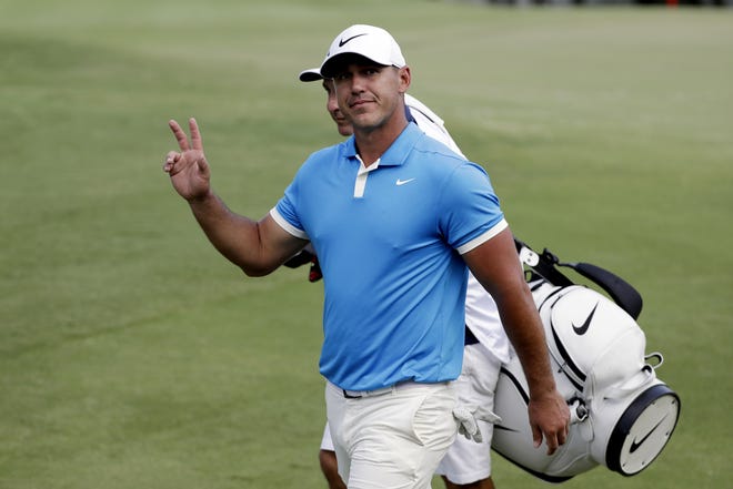 Brooks Koepka waves to the crowd as he leaves the 18th green after winning the World Golf Championships-FedEx St. Jude Invitational on Sunday, July 28, 2019, in Memphis, Tenn. Koepka leads the FedExCup season points standings on the PGA Tour. [MARK HUMPHREY/THE ASSOCIATED PRESS]