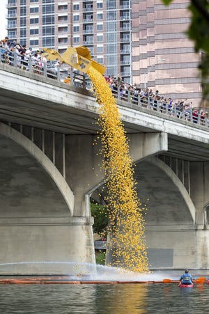 A dump truck poured nearly 20,000 rubber ducks from the Ann W. Richards Congress Avenue Bridge into Lady Bird Lake as part of the 5th Annual Austin Duck Derby in 2018. All proceeds from the derby benefit the Austin Boys and Girls Club Foundation. [Lynda M. Gonzalez / AMERICAN-STATESMAN]