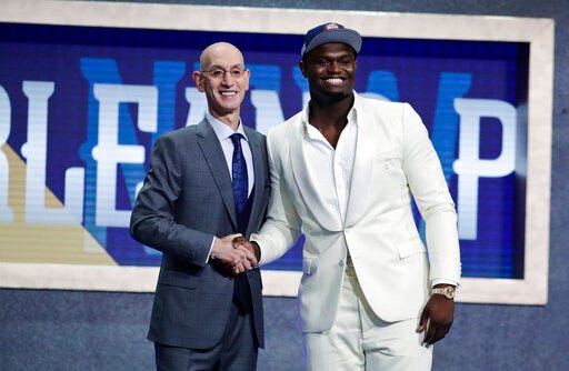 FILE - In this June 20, 2019, file photo, Duke's Zion Williamson, right, poses with NBA Commissioner Adam Silver after being selected by the New Orleans Pelicans as the first pick during the NBA basketball draft, in New York. Picked No. 1 in the NBA draft. Signed his first pro contract that could be worth as much as $45 million over the next four years. Went to summer league and got hurt after nine minutes. Landed a massive endorsement deal with Jordan Brand. And now, a video game deal. Williamson has signed with 2K, he and the video-game giant announced Tuesday, July 30, 2019, and the former Duke standout will make his video-game debut in NBA 2K20 when it launches on Sept. 6.(AP Photo/Julio Cortez, File)