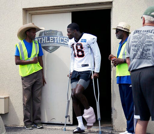 Cincinnati Bengals wide receiver A.J. Green (18) leaves practice early with an injury to his left ankle area during NFL football training camp at Welcome Stadium in Dayton, Ohio, on Saturday, July 27, 2019. (Sam Greene/The Cincinnati Enquirer via AP)