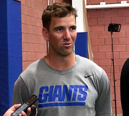 New York Giants quarterback Eli Manning talks to reporters at the teams's NFL football training facility in East Rutherford, N.J., Tuesday, July 30, 2019. (AP Photo/Tom Canavan)