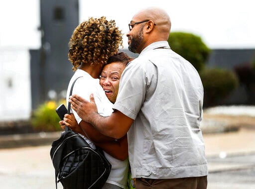 People embrace outside a Walmart store following a shooting Tuesday, July 30, 2019, in Southaven, Miss. A gunman fatally shot two people and wounded a police officer before he was shot and arrested Tuesday at the Walmart in northern Mississippi, authorities said. (Mark Weber/Daily Memphian via AP)