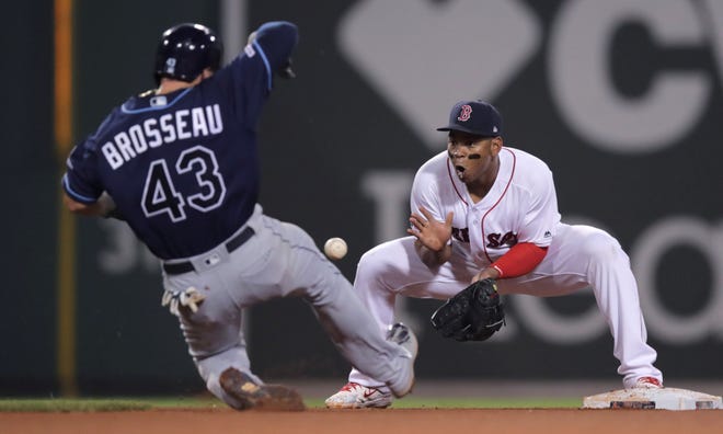 Tampa Bay's Michael Brosseau (43) advances to second on a ball hit by Nate Lowe as Boston third baseman Rafael Devers covers the base during MLB action on Tuesday. [AP photo]
