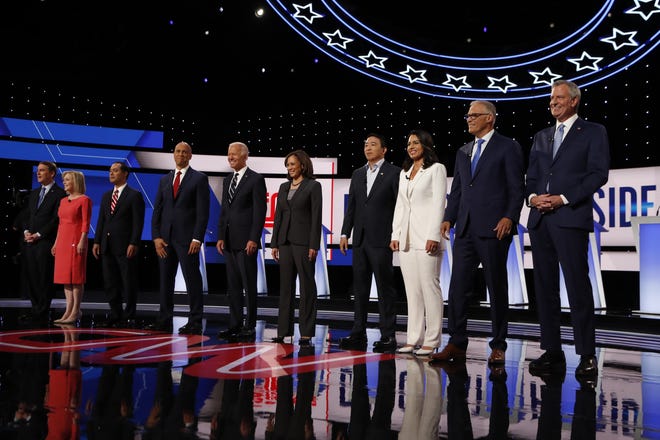 Sen. Michael Bennet, D-Colo., from left, Sen. Kirsten Gillibrand, D-N.Y., former Housing and Urban Development Secretary Julian Castro, Sen. Cory Booker, D-N.J., former Vice President Joe Biden, Sen. Kamala Harris, D-Calif., Andrew Yang, Rep. Tulsi Gabbard, D-Hawaii, Washington Gov. Jay Inslee and New York City Mayor Bill de Blasio are introduced before the second of two Democratic presidential primary debates hosted by CNN Wednesday in the Fox Theatre in Detroit. [CARLOS OSORIO/THE ASSOCIATED PRESS]