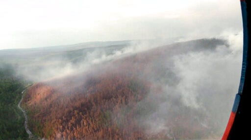 This image made from video provided by RU-RTR Russian television channel shows a view of a forest fire in the Boguchansky district of the Krasnoyarsk region, Russia Far East, Wednesday, July 31, 2019. Russian President Vladimir Putin has ordered Russia's military to join efforts to fight forest fires that have engulfed nearly 30,000 square kilometers (11,580 sq. miles) of territory in Siberia and the Russian Far East. (RU-RTR Russian Television via AP)