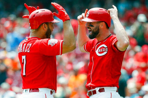 Cincinnati Reds' Eugenio Suarez, left, celebrates with Jesse Winker after hitting a two-run home run off Pittsburgh Pirates starting pitcher Dario Agrazal in the third inning of a baseball game, Wednesday, July 31, 2019, in Cincinnati. (AP Photo/John Minchillo)