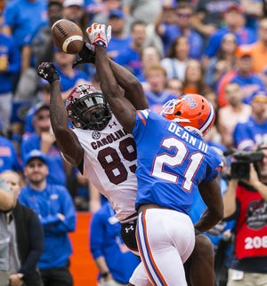 Florida defensive back Trey Dean III (21) breaks up the pass intended for South Carolina wide receiver Bryan Edward. Dean is picking up a new position in the secondary this season. [Cyndi Chambers/Correspondent]