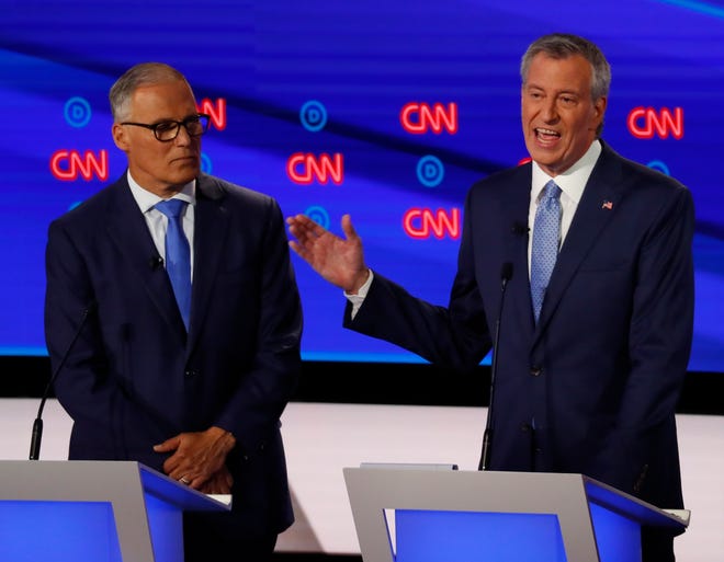Washington Gov. Jay Inslee and New York City Mayor Bill de Blasio, right, participate in the second of two Democratic presidential primary debates hosted by CNN Wednesday, July 31, 2019, in the Fox Theatre in Detroit. (AP Photo/Paul Sancya)