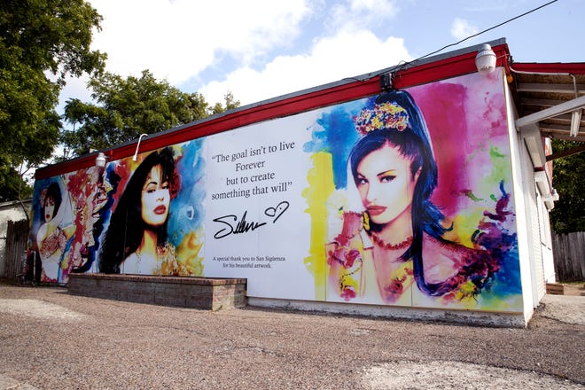 This Tuesday, July 30, 2019 photo, shows a new Selena mural by San Siguenza that was installed on the exterior of the Food Store in the Molina neighborhood of Corpus Christi, Texas. The previous mural was painted by West Oso High School students in 1995 as a neighborhood tribute to Selena Quintanilla-Perez. (Rachel Denny Clow/Corpus Christi Caller-Times via AP)