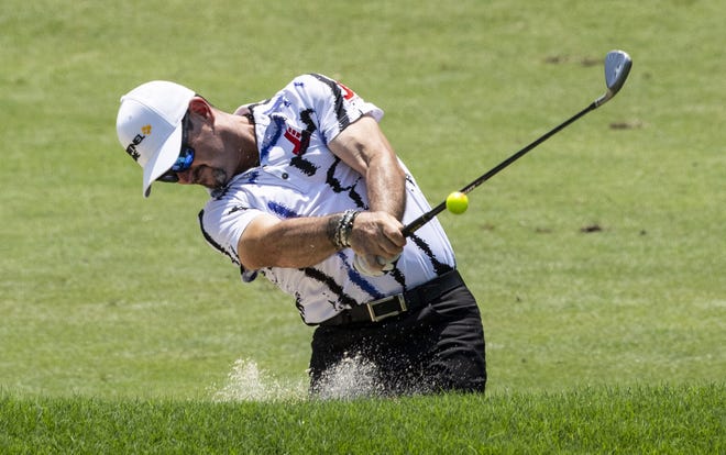 Rory Sabbatini takes his second shot out of a fairway bunker on the ninth hole at the Wyndham Championship on Thursday in Greensboro, N.C. The tournament is scheduled to continue on Friday. [WOODY MARShALL/NEWS & RECORD VIA AP]