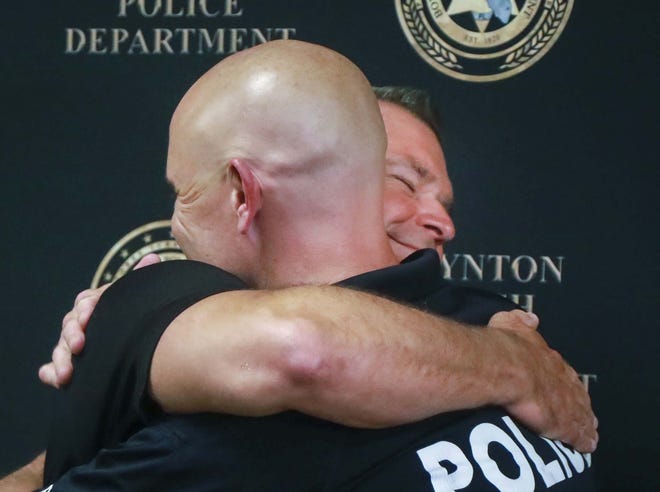 Orange County Sheriff´s Office Sergeant David Stull smiles as he and Boynton Beach Police Officer Eric Reynolds hug at the conclusion of a press conference at the Boynton Beach Police Department Friday morning. After having sent DNA to 23andMe in 2016 to learn more about his family´s ancestry and health information, Reynolds discovered this summer that he had a half-brother whom he had never met and who also worked in law enforcement. Reynolds and Stull met for the first time at Stull´s home on July 20. “It was like meeting a clone of me,Ó Reynolds said. “We´re alike in so many ways. I have someone I can talk to and trust as brothers and cops. It feels great.Ó

Stull visited Reynolds and his family in Boynton Beach yesterday. [BRUCE R. BENNETT/palmbeachpost.com]