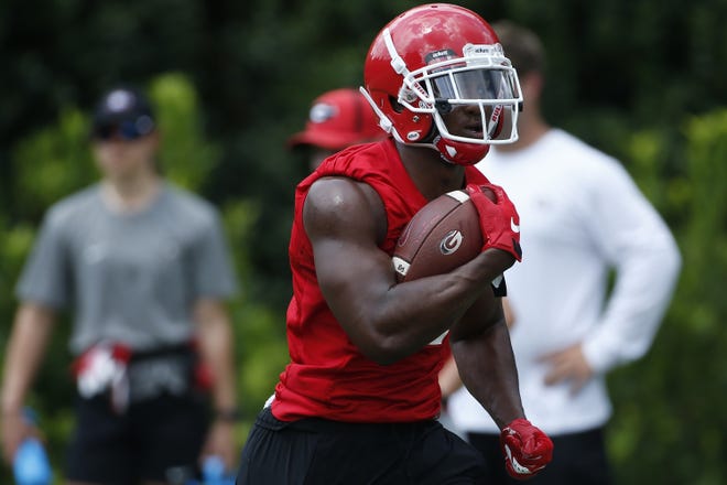 Georgia running back Zamir White runs a drill Friday during the Bulldogs' first day of practice. White is coming back from an ACL injury that forced him to miss all of his freshman season. [JOSHUA L. JONES/ATHENS BANNER-HERALD]