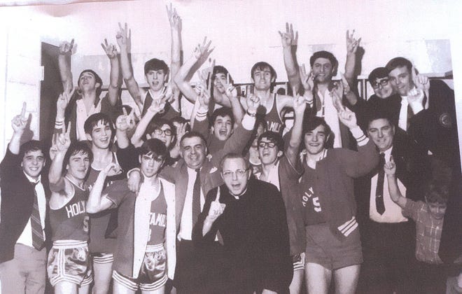 The 1968-69 Holy Family boys basketball team celebrates its 1969 state championship. [STANDARD-TIMES FILE PHOTO]