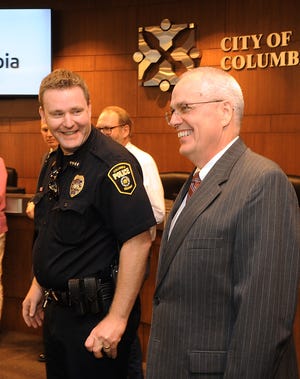 Interim Columbia Police Chief Geoff Jones, left, jokes on July 15 with newly named City Manager John Glascock after Mayor Brian Treece announced Glascock had been chosen for the job. [Don Shrubshell/Tribune]