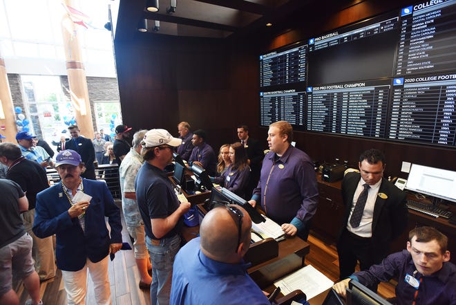 Guests place bets during the opening to the Lounge with Caesars Sports Thursday, August 1, 2019 at Turning Stone Resort Casino in Verona which offers sports betting, dining and sports viewing areas. [Sarah Condon / Observer-Dispatch]