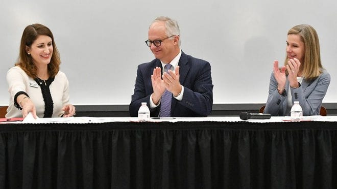 On July 16, 2019, Polk State College President Angela Garcia Falconetti, left, and Florida Polytechnic University President Randy Avent sign an agreement that eases the process for Polk State students to transfer to Florida Poly. Florida College System Chancellor Kathy Hebda looks on.