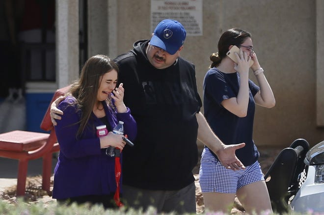 People arrive at MacArthur Elementary looking for family and friends as the school is being used a re-unification center during the aftermath of a shooting at the Walmart near the Cielo Vista Mall Saturday in El Paso, Texas. [Briana Sanchez/The El Paso Times via AP]