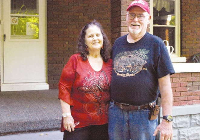 David Culp poses with his wife, Brenda, in front of the Harvest House while they were serving as the resident managers of the shelter. [GateHouse Missouri file photo]
