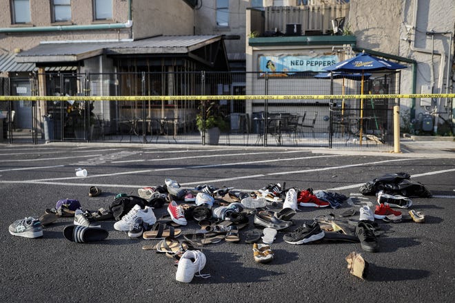 Shoes are piled outside the scene of a mass shooting including Ned Peppers bar, Sunday in Dayton, Ohio. Several people in Ohio have been killed in the second mass shooting in the U.S. in less than 24 hours, and the suspected shooter is also deceased, police said. [John Minchillo/The Associated Press]
