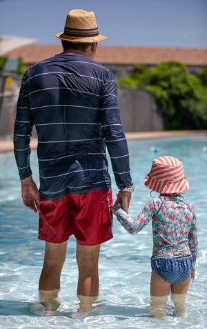 Portia Serrato, 3, and her father, Benjamin enjoy an afternoon at Springwoods Pool. The two are on a quest to visit every pool in Austin this summer. [ELI IMADALI/AMERICAN-STATESMAN]