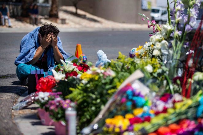 Felipe Avila puts his head in his hands as he cries Sunday in El Paso, Texas, at the place where locals came to honor the memory of the victims of the mass shooting Saturday in Walmart.