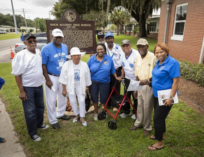 Union Academy alumni, including former NFL great Ken Riley, fourth from right, the president of school's alumni association, pose by a historic marker that commemorates Polk County's first black school's 122nd anniversary and the 50th anniversary of its last pre-desegregation graduating class.
