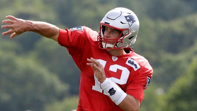 New England Patriots quarterback Tom Brady follows through on a pass during an NFL football training camp practice last week in Foxborough, Mass.