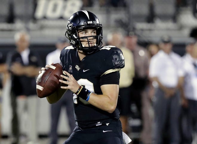 Central Florida quarterback McKenzie Milton looks for a receiver during the first half of an NCAA college football game against Florida Atlantic in Orlando Sept. 21, 2018. Part of the sales pitch that lured Milton from his home state of Hawaii to UCF was a pledge by then-Knights coach Scott Frost to help put the quarterback on a path to a post-playing career in coaching. JOHN RAOUX/THE ASSOCIATED PRESS