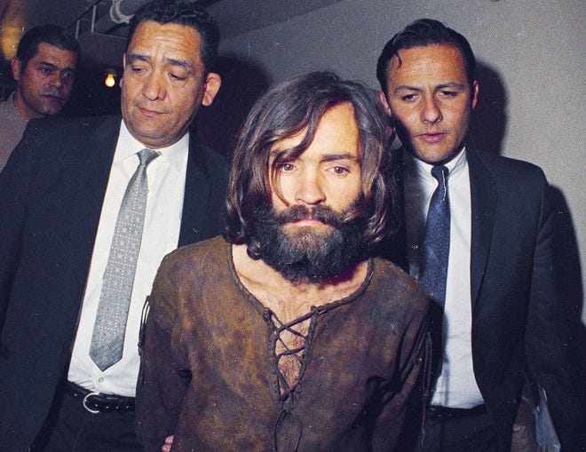 In this 1969 file photo, Charles Manson is escorted to his arraignment on conspiracy-murder charges in connection with the Sharon Tate murder case in Los Angeles. Fifty years ago Manson dispatched a group of disaffected young hippie followers on a two-night killing spree that terrorized Los Angeles and in the years since has come to represent the face of evil. On successive nights in August 1969, the so-called Manson family murdered seven people. [ASSOCIATED PRESS]