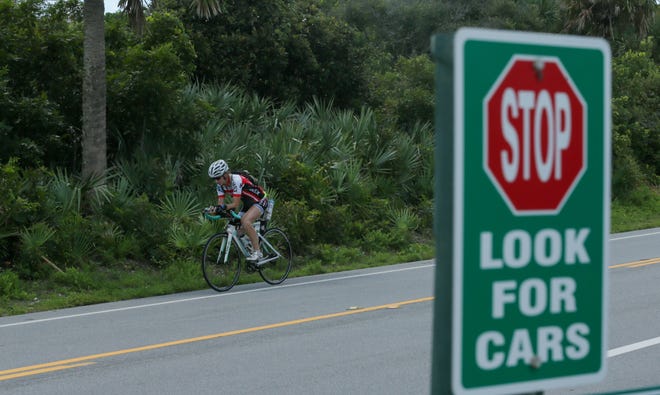 A cyclist rides along the shoulder on the northbound lane of State Road A1A on Tuesday morning. The Florida Department of Transportation will fund a feasibility study to determine whether a trail should be built for cyclists and pedestrians along A1A from Vilano Beach to Mikler Road. [Will Brown/The Record]