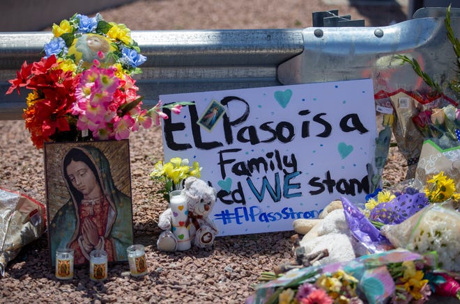 In this Sunday, Aug. 4, 2019, file photo, flowers and a Virgin Mary painting adorn a makeshift memorial for the victims of Saturday mass shooting at a shopping complex in El Paso, Texas. (AP Photo/Andres Leighton, File)