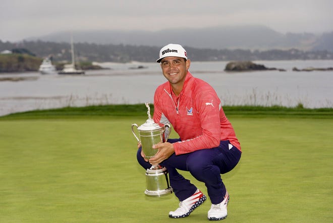 From June 16, 2019, Gary Woodland posses with the trophy after winning the U.S. Open Championship golf tournament in Pebble Beach, Calif. Woodland says he couldn't truly enjoy winning the Open until his wife gave birth to twin girls last week. (AP Photo/Carolyn Kaster, File)
