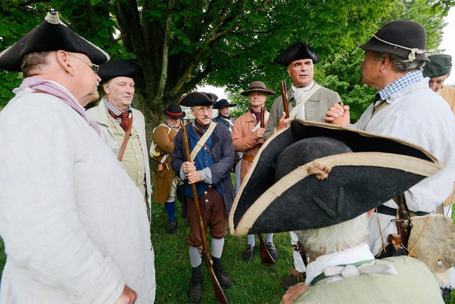 Amsterdam resident Jim Sparks, center, talks with fellow reenactors before the start of the Battle of Oriskany commemoration on Tuesday at the Oriskany Battlefield State Historic Site. [ALEX COOPER/OBSERVER-DISPATCH]