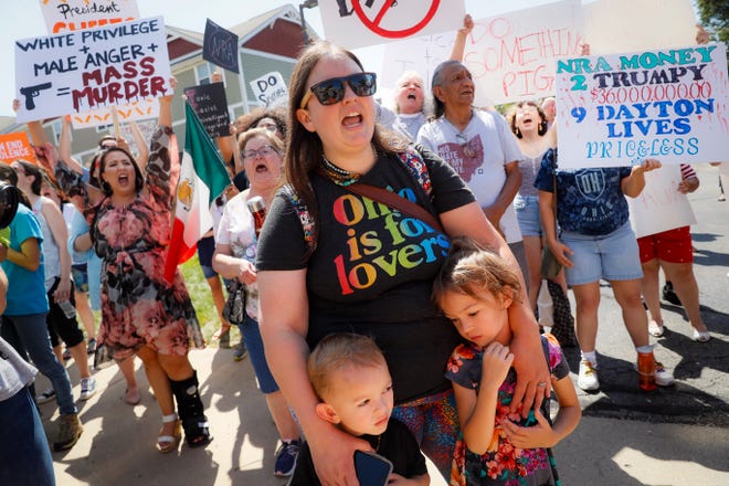 Demonstrators chant as they protest the arrival of President Donald Trump on Wednesday outside Miami Valley Hospital after a mass shooting that occurred in the Oregon District early Sunday morning in Dayton. [John Minchillo/The Associated Press]