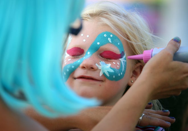 Olivia Bryant, 4, gets her face painted at Patriots Park in Kings Mountain for National Night Out on Tuesday. [Brittany Randolph/The Star]