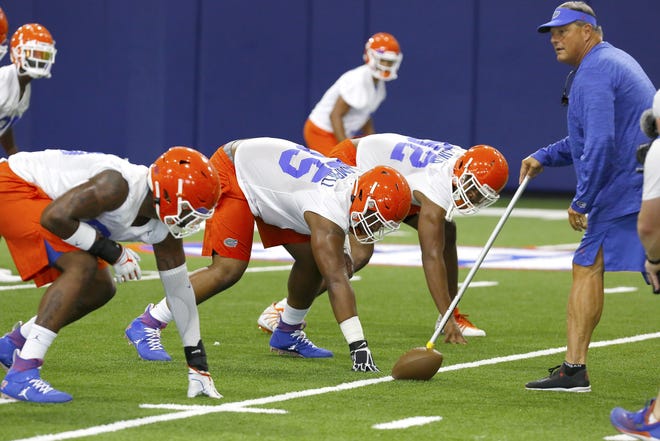 Florida defensive coordinator Todd Grantham works with the defensive line during a drill. [Brad McClenny/Staff photographer]